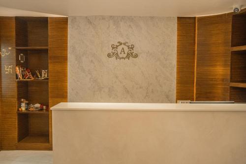 a lobby with a counter with a pirate sign on the wall at Hotel Arjay Valley, Pure Veg Luxury Hotel in Darjeeling
