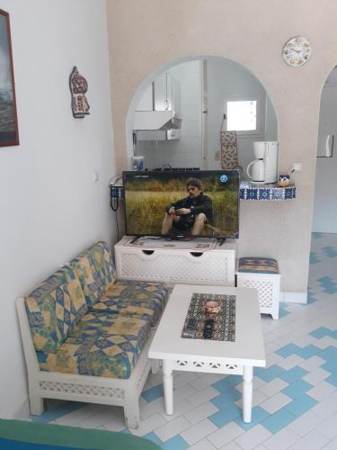 a man sitting on a couch in a living room at Tulip in Sousse