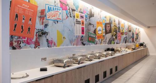 a counter with a row of pots and pans at Best Western Plus The Quays Hotel Sheffield in Sheffield