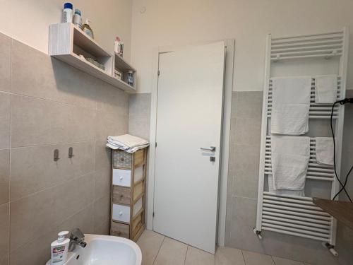 a bathroom with a white sink and a mirror at B&B Il giardino segreto in Guarda Ferrarese