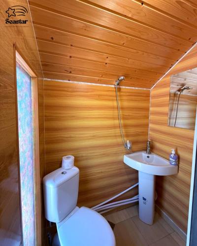 a small bathroom with a toilet and a sink at Sea Star in Sevan