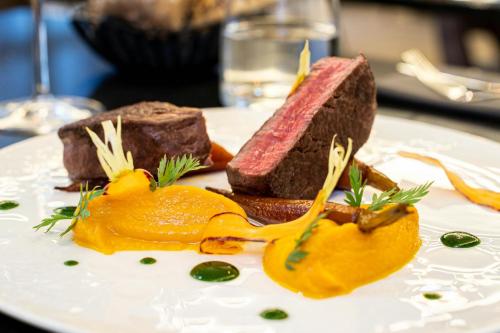 a white plate with some food on a table at Courtyard by Marriott Paris Porte de Versailles in Issy-les-Moulineaux