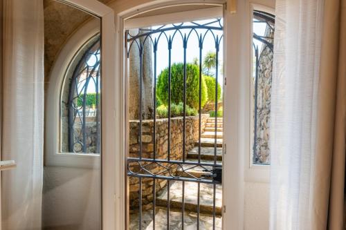 a door leading into a room with a window at L'appartement de la mouline avec domaine privée in Pézenas