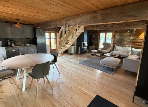 a kitchen and living room with a table and chairs at Arctic Private Island - All inclusive HB and activities in Rovaniemi