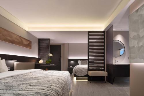 a hotel room with a bed and a mirror at The S Heartland Hotel Chengdu（by Taikoo Li） in Chengdu