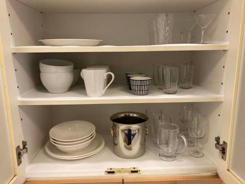 a cupboard filled with dishes and other kitchen items at sunset hills - Vacation STAY 21373v in Hamada
