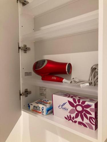 a shelf with a red bottle and a box on it at sunset hills - Vacation STAY 21373v in Hamada