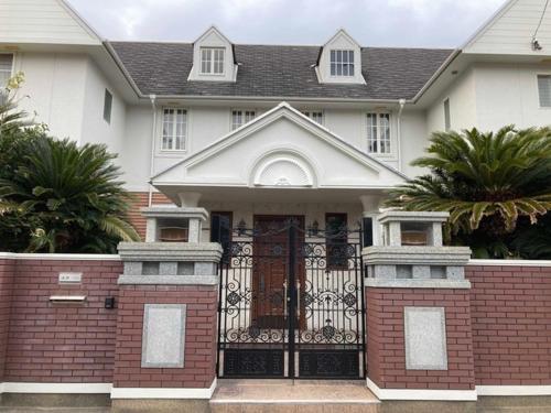 a house with a black gate in front of it at sunset hills - Vacation STAY 21373v in Hamada