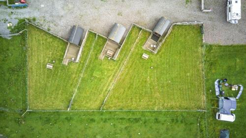 an overhead view of a field with grass and cars at Unit 4 - Skiddaw View Camping Pod in Carlisle