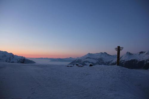 a cross on top of a snow covered mountain at Haus am Rain in Partenen