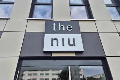 a sign on the side of a building at Holiday Inn - the niu, Pax Berlin Airport by IHG in Berlin