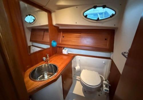 a small bathroom with a sink and a toilet at Bateau 6 personnes Larmor Plage in Larmor-Plage