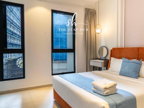 a bedroom with a bed and a window at Paxtonz Luxe Suites - Damansara - PJ - by The Stay Hub in Kampong Bukit Lanjan