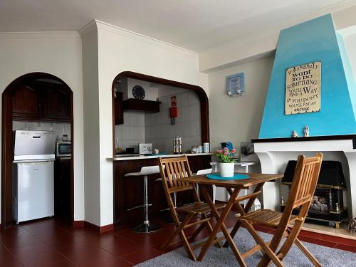 a kitchen with a table and chairs in a room at Casa da Areia Branca in Bolembre de Baixo