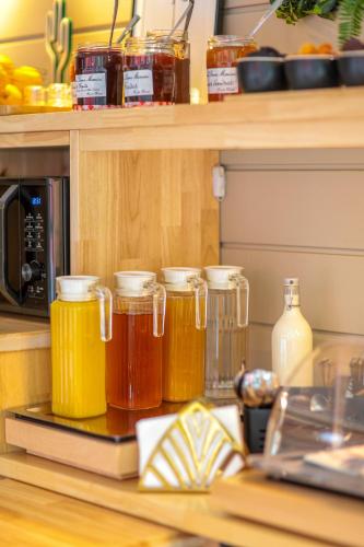 a kitchen counter with jars of honey and a microwave at Ostal Pau Universite - Sure Hotel Collection by Best Western in Pau