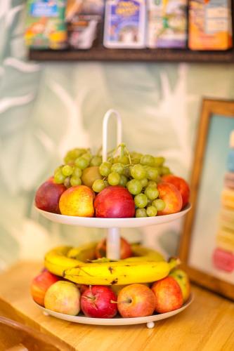 a three tiered display of fruit on a table at Ostal Pau Universite - Sure Hotel Collection by Best Western in Pau