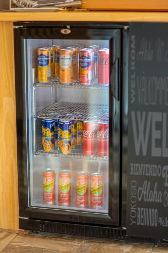a refrigerator filled with cans of soda at Ostal Pau Universite - Sure Hotel Collection by Best Western in Pau