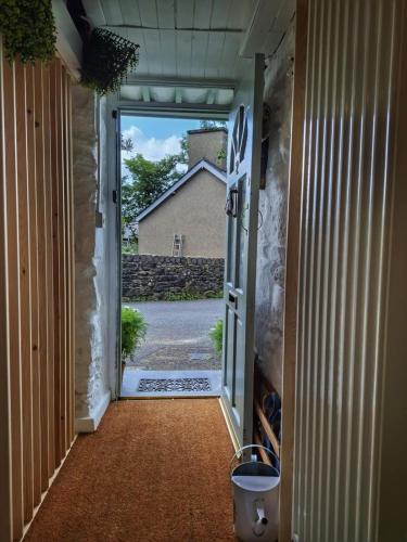 an open door with a view of a house at Waterfall retreat in Blaenau-Ffestiniog