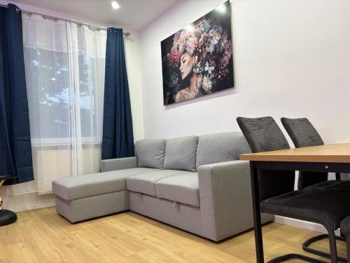 a living room with a couch and a table at City Line Koblenz in Koblenz