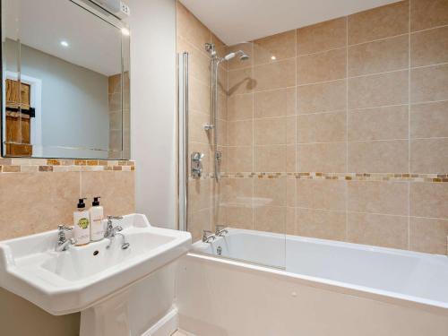 a bathroom with a sink and a tub and a shower at 3 Bed in Corton Denham 44051 in Pointington
