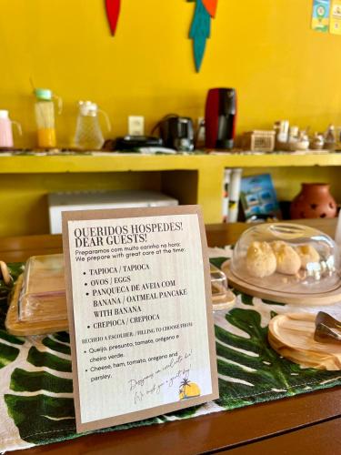 a menu on a table with plates of food at The Jungle, Village & Beach in Guriú