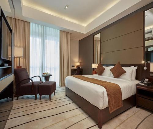 a hotel room with a large bed and a desk at Hotel Delta international Near Delhi Airport in New Delhi