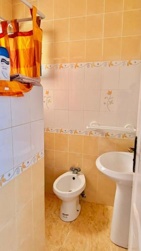 a bathroom with a toilet and a sink at Seaview Apartments in Raoued