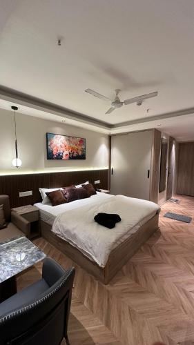 a large bedroom with a large bed and a couch at Easy Stayz - Premium stays in Greater Noida in Greater Noida