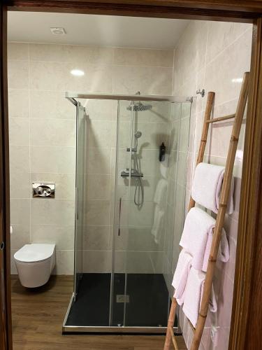 a shower with a glass door in a bathroom at Casa da Saboaria in Almeida