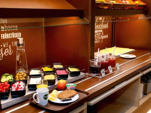 a buffet line with different types of food at B&B HOTEL München-Airport in Hallbergmoos