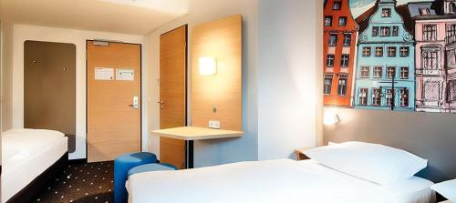 Кровать или кровати в номере B&B Hotel Rostock City-West