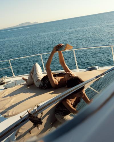 two people laying on the deck of a boat at Banyan Tree Tamouda Bay in Fnidek