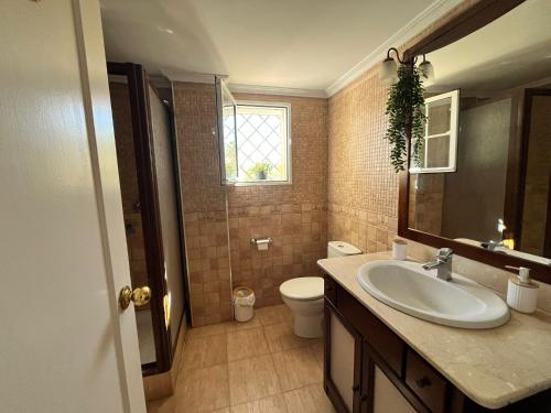 a bathroom with a sink and a toilet and a window at Beautiful apartment in Calahonda beach in Sitio de Calahonda