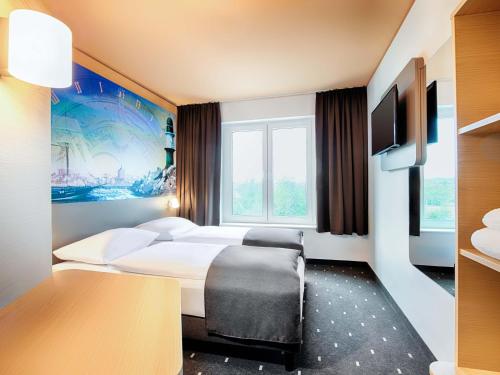 Кровать или кровати в номере B&B Hotel Rostock-Hafen