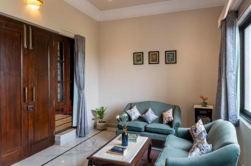 a living room with a couch and a table at Dilip Niwas in Udaipur