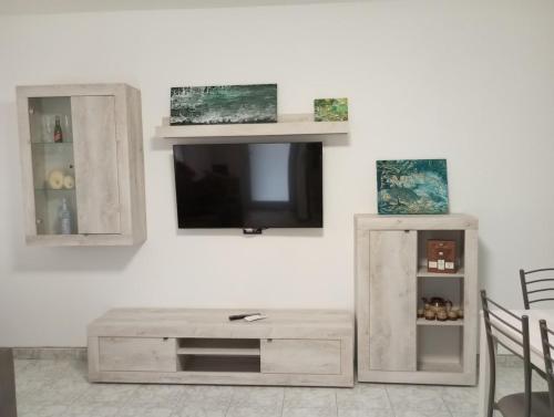 a living room with a tv on a white wall at Almes' home in Bosisio Parini