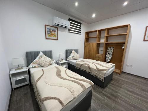 a room with two beds and a desk and a bed sidx sidx sidx at Ferienwohnungen Yanev- Hof in Hof