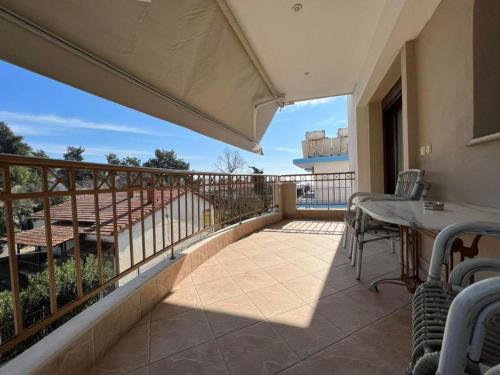 a balcony with a table and chairs on it at Kappa Rooms Boutique Double Room in Nea Kalikratia