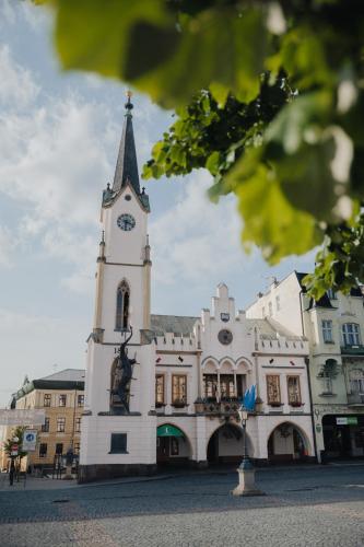 a building with a clock tower in front of it at Apartmán Radvanička in Radvanice
