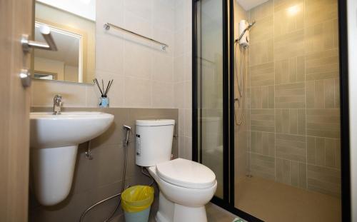 a bathroom with a toilet and a sink and a shower at Entire apartment in Kathu, Phuket, Thailand in Kathu