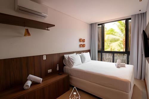 Postel nebo postele na pokoji v ubytování Condomínio Aluá, Vista Infinita na Praia do Patacho, Pé na areia!