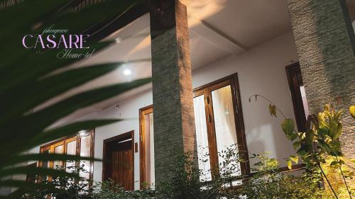 a building with windows and plants in front of it at Casare Phu Quoc - Formerly Caesar Hotel in Phu Quoc