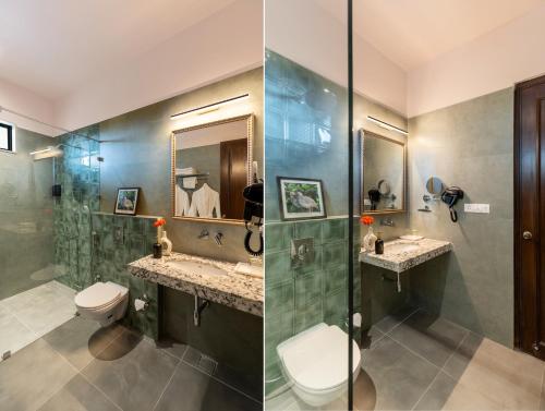 a bathroom with two sinks and a toilet and a shower at Dilip Niwas in Udaipur