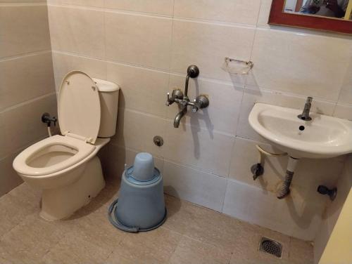 a bathroom with a toilet and a sink at Hotel O RKH Residency in Chennai