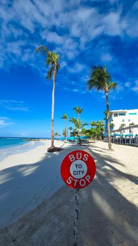 a bus to city stop sign on a beach at T.Cole’s Holiday Rental in Saint James