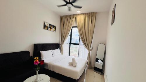 a bedroom with a white bed and a window at Trion Signature Luxe Suites KL in Kuala Lumpur