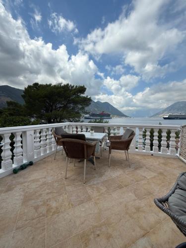 a patio with a table and chairs on a balcony at Apartment LANA on the seashore in Kamenarovići