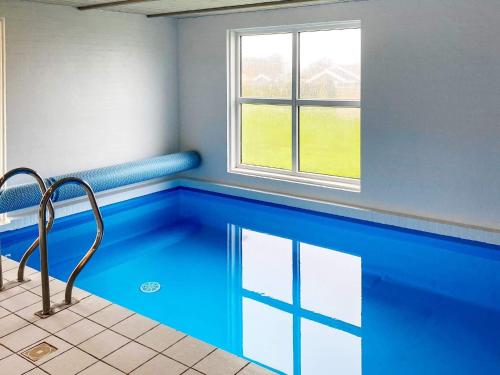 a swimming pool in a room with a window at 4 star holiday home in Nordborg in Nordborg