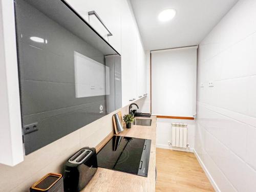 a bathroom with a sink and a mirror at Suite Ateneo By Silastur in Gijón