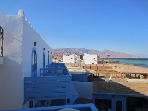 a view of a building with the ocean in the background at El Primo Hotel Dahab in Dahab